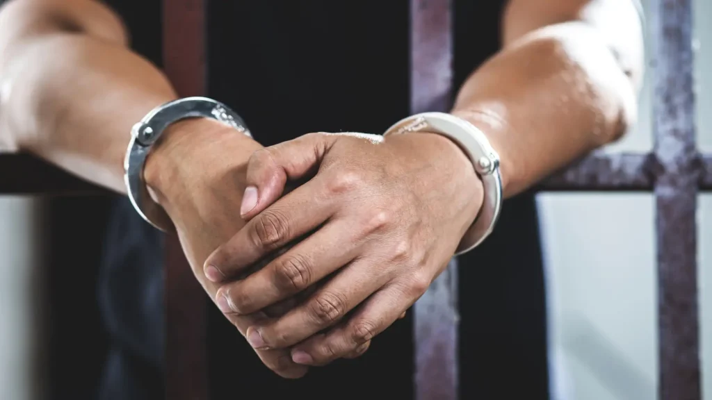 Close-up of person’s hands in handcuffs
